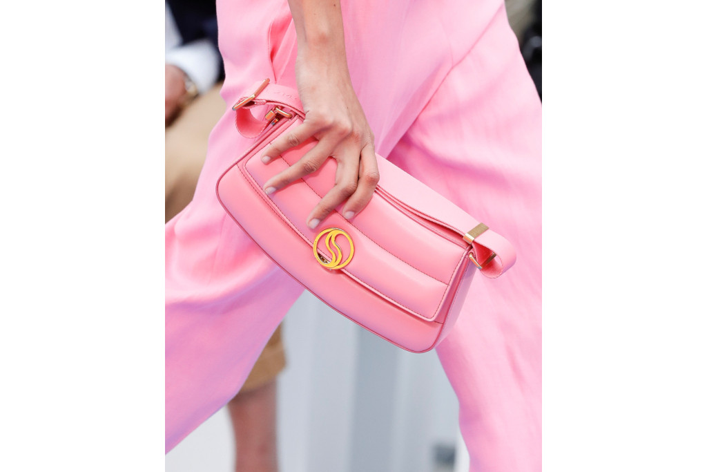 Close up of woman in pink holding pink bag | vegan fashion brands