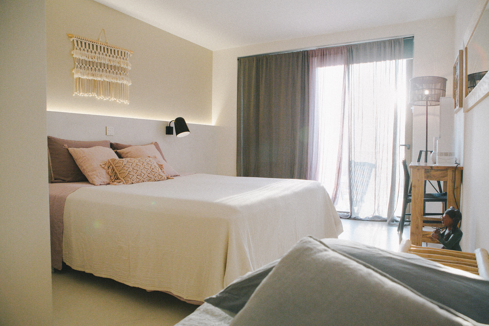 a light and spacious bedroom with white bed sheets and pink pillows