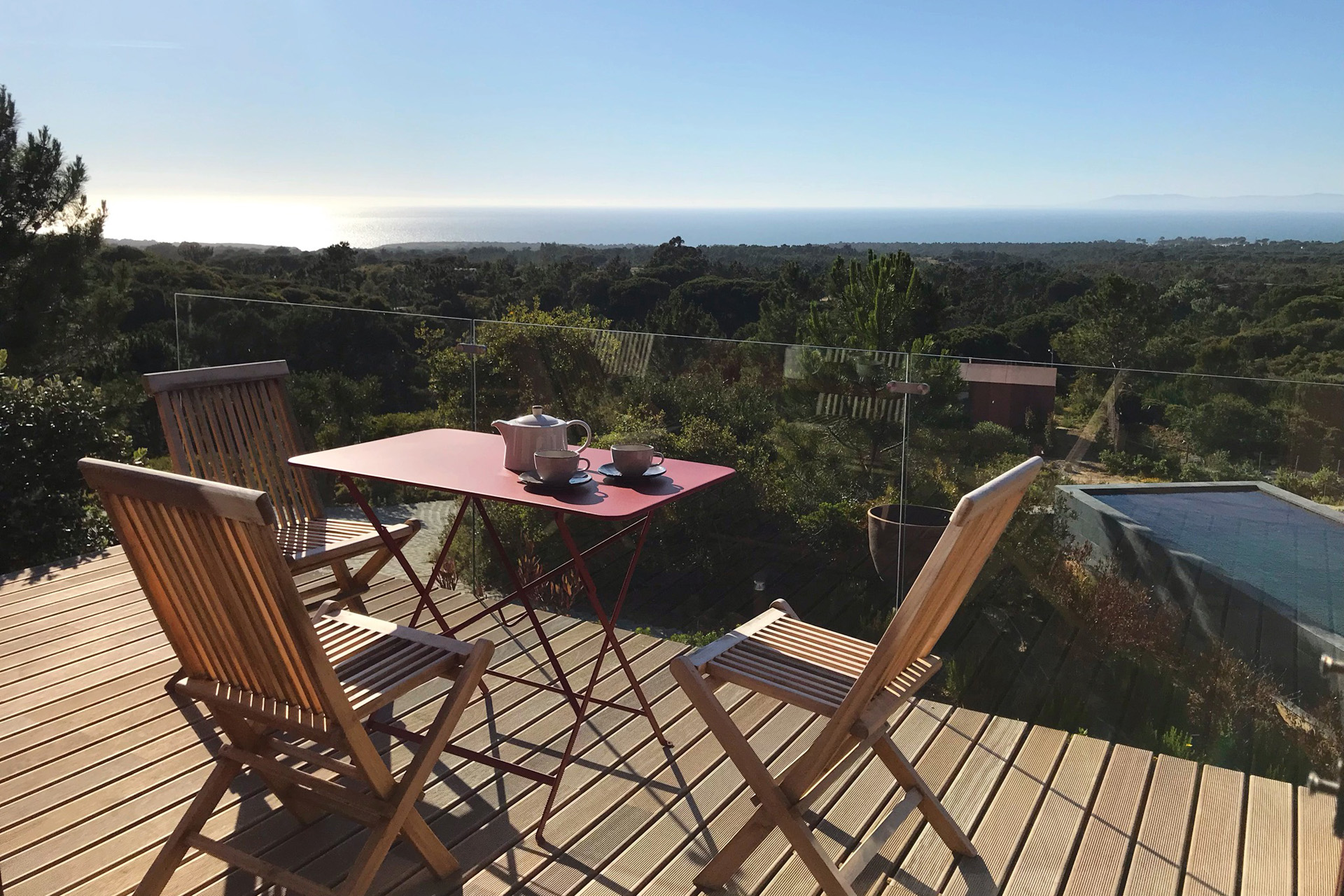 an Eco-Villa terrace overlooking the swimming pool at Villa Epicurea