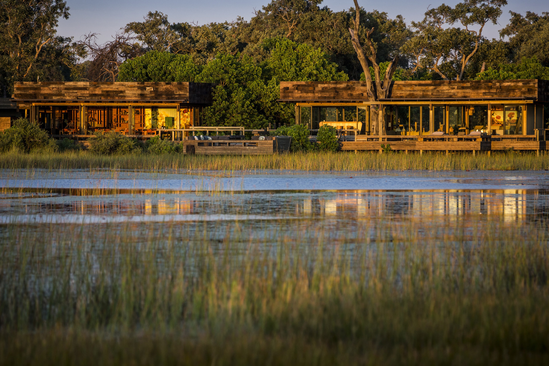 a safari camp, vumbura, in botswana, at sunset