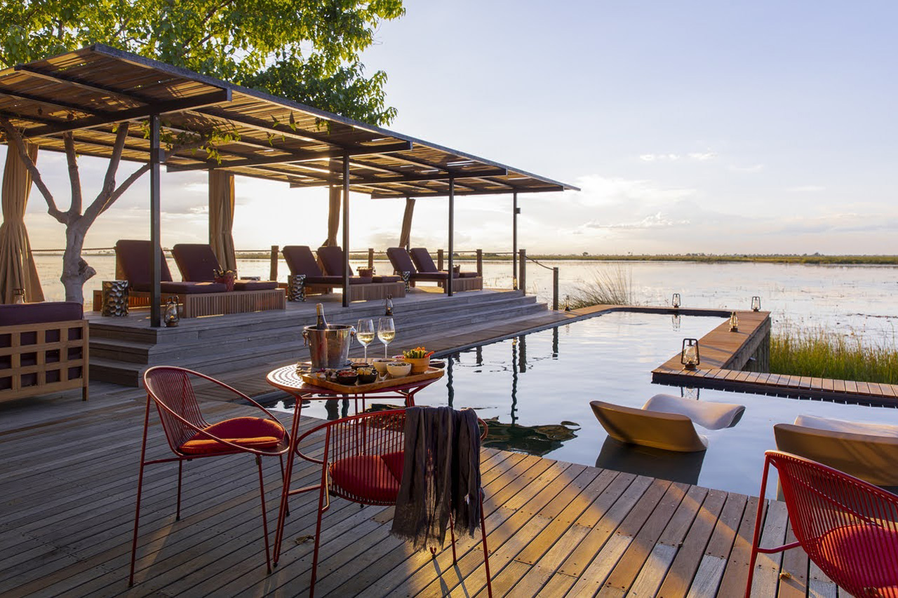 sunbeds overlooking a pool and lake