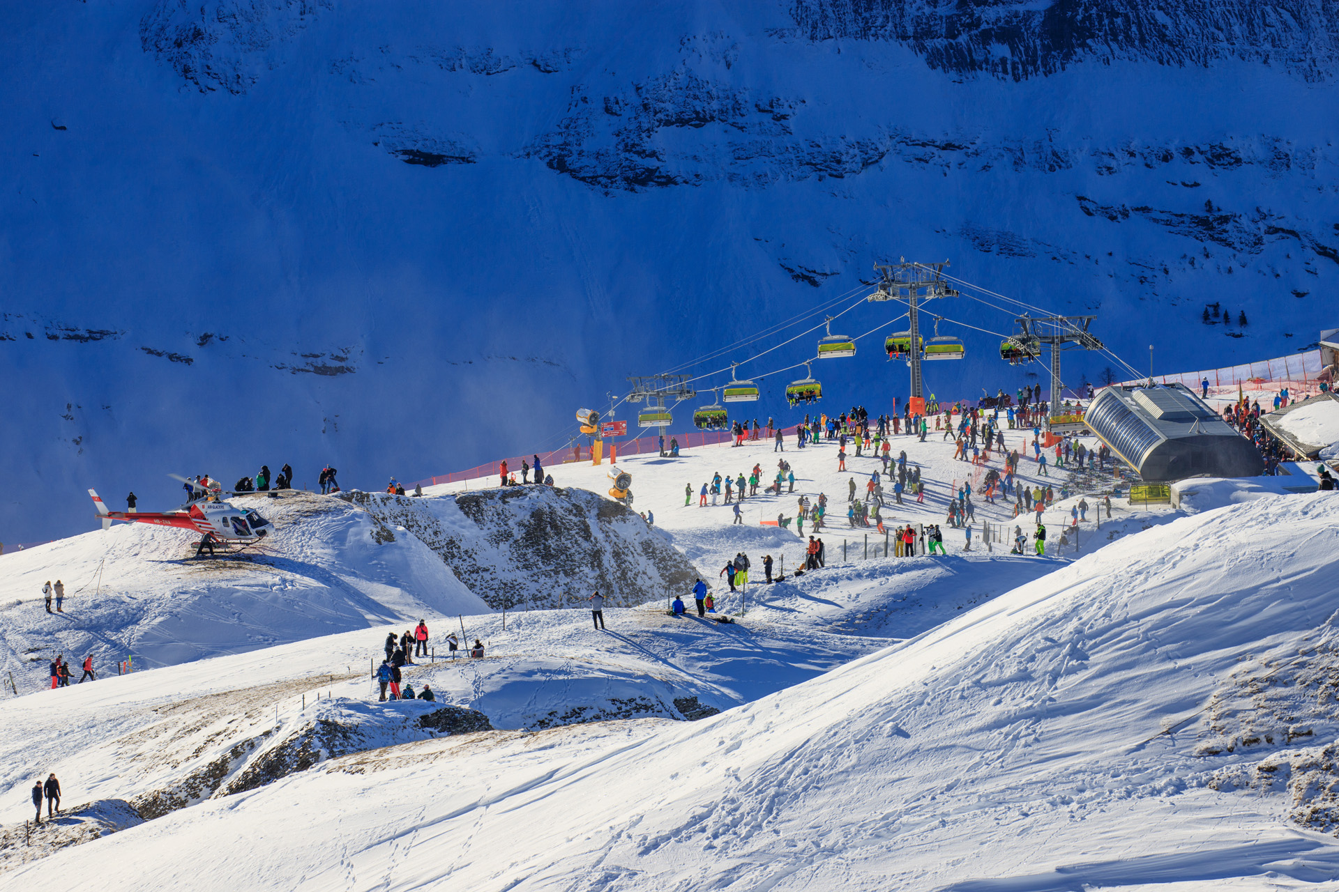 View of the ski resort Jungfrau Wengen with snow, cable cars and skiers