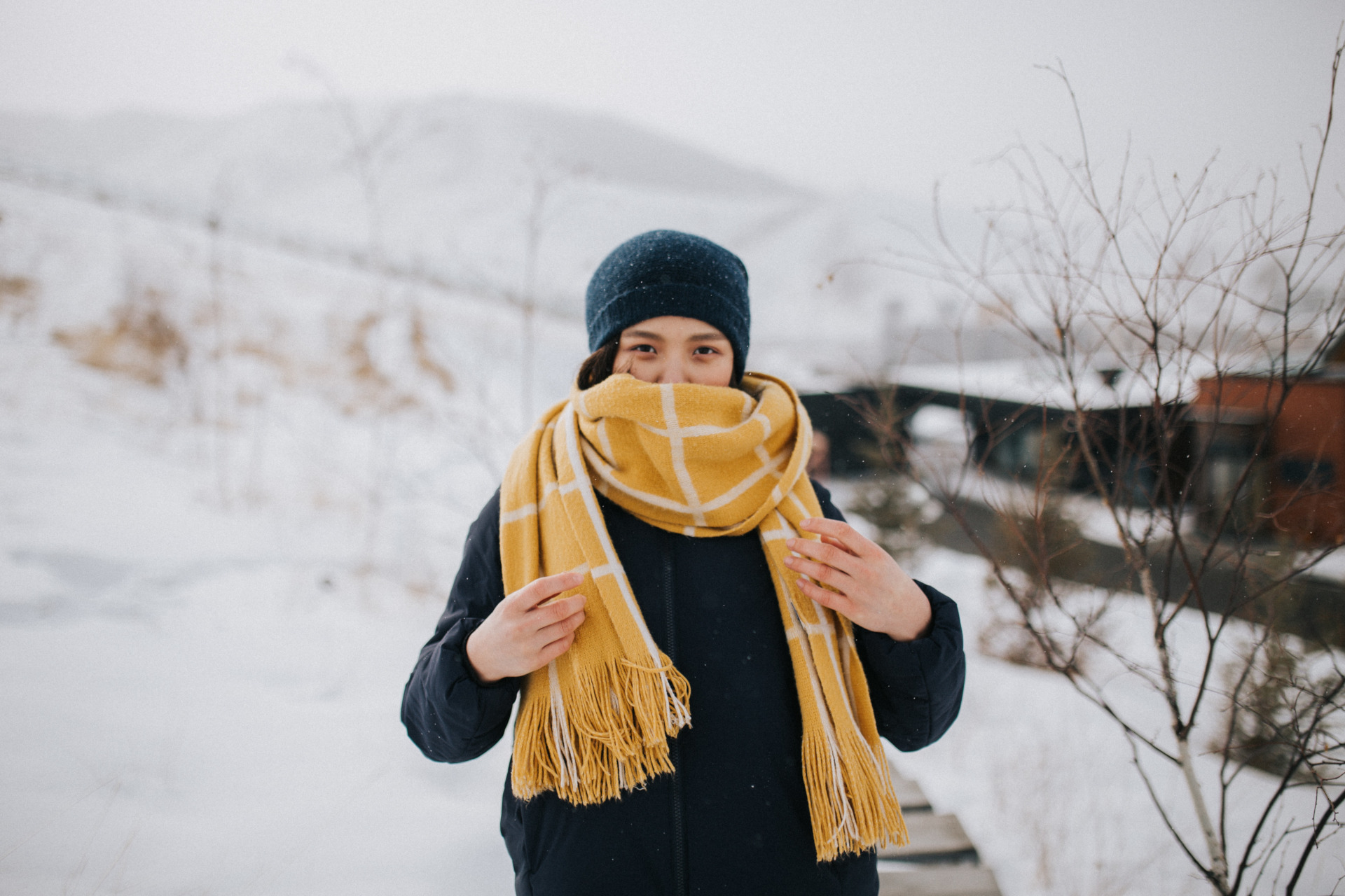 Woman in snow wearing yellow scarf