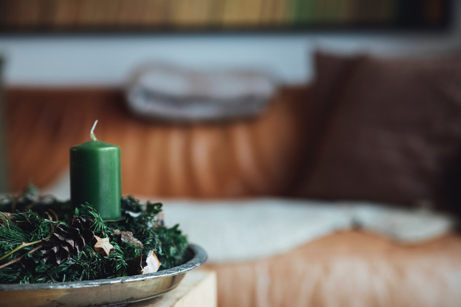 Green candle in pine branches