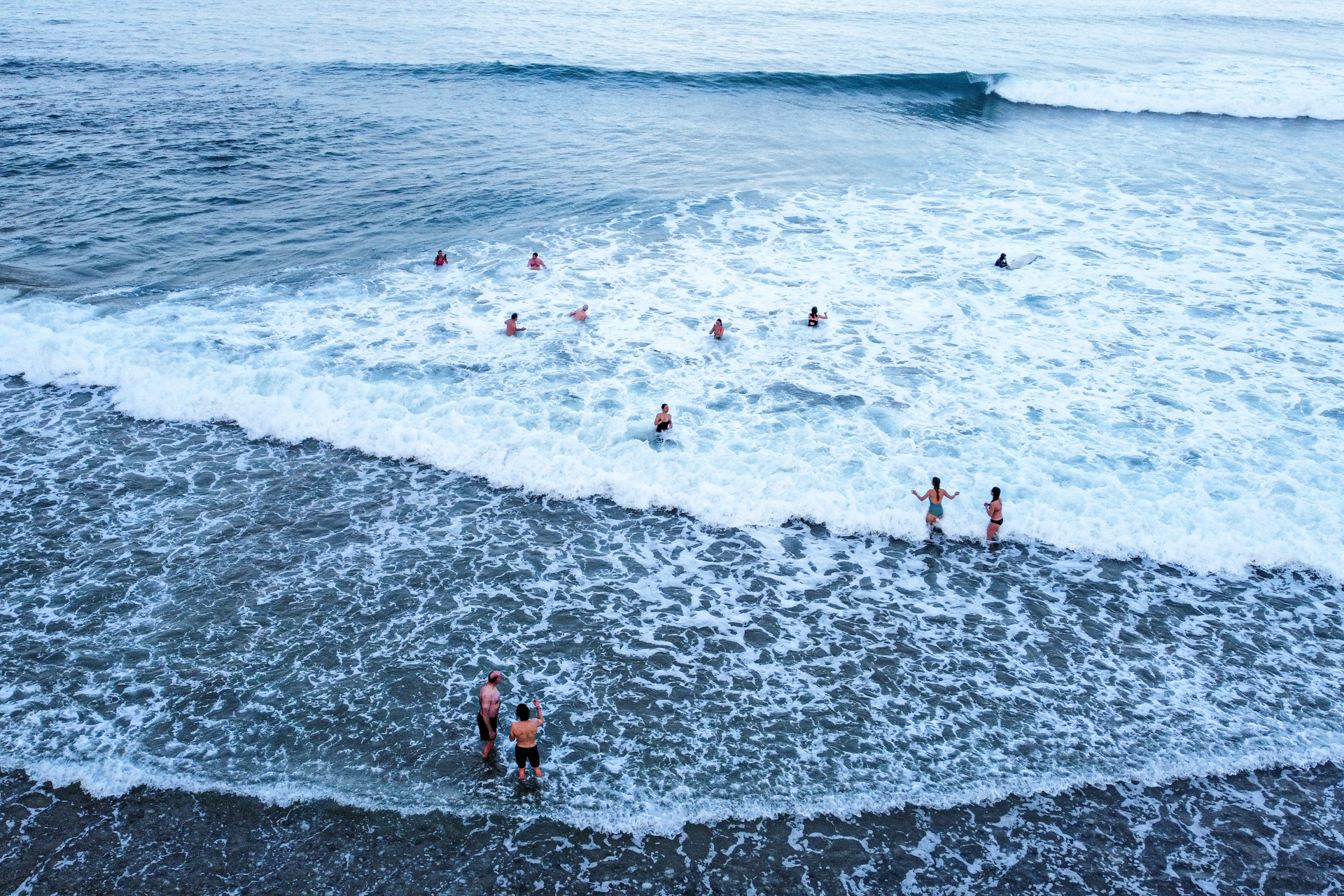 people swimming in the sea in cornwall