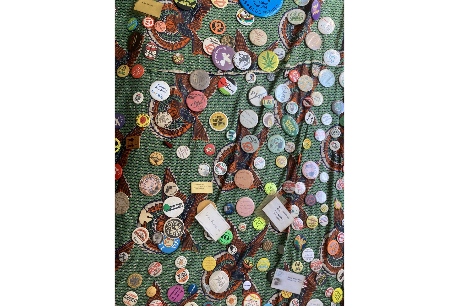Keith's Funeral Shroud covered in protest badges from the 1980s and 1990s