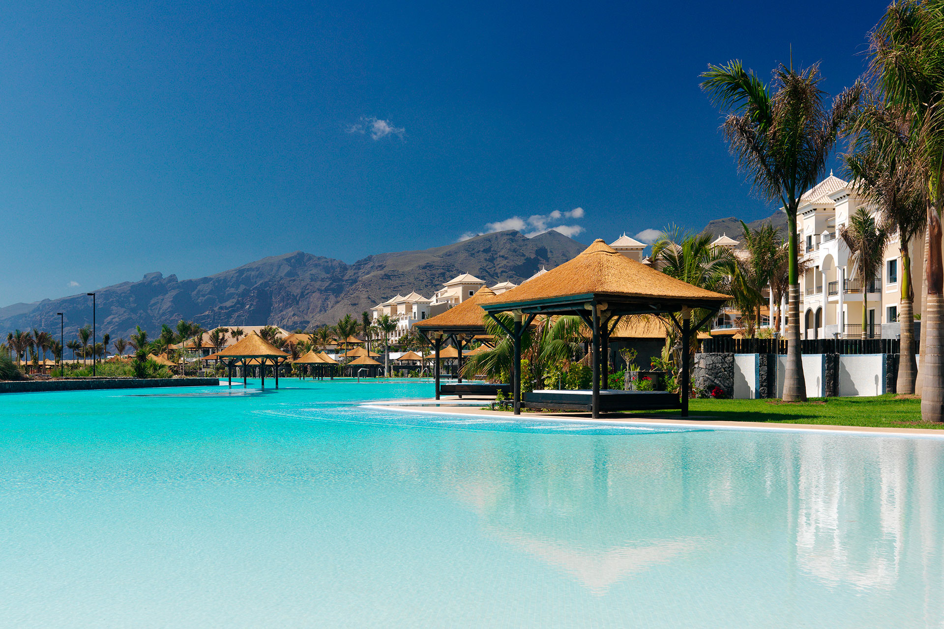 poolside view with sunbed huts at te side