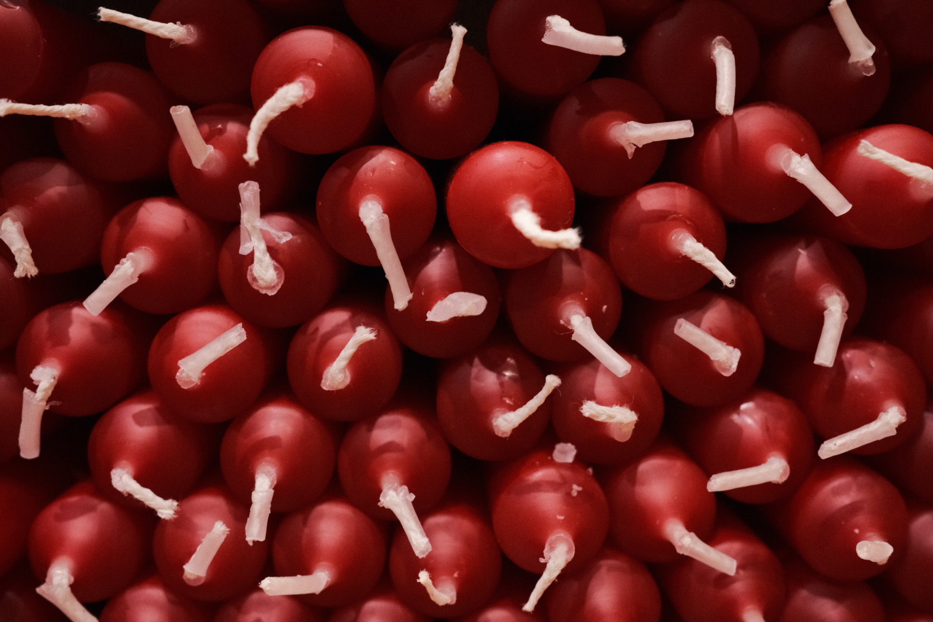 Overhead view of red candles with white wicks