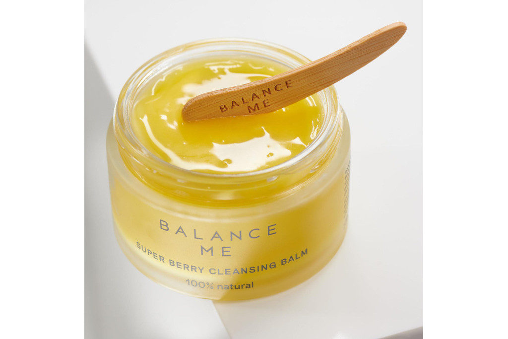 Tub of skin cream with a spreading stick on top
