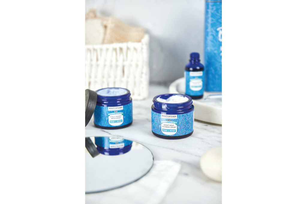 Blue tubs and bottle on white wooden table