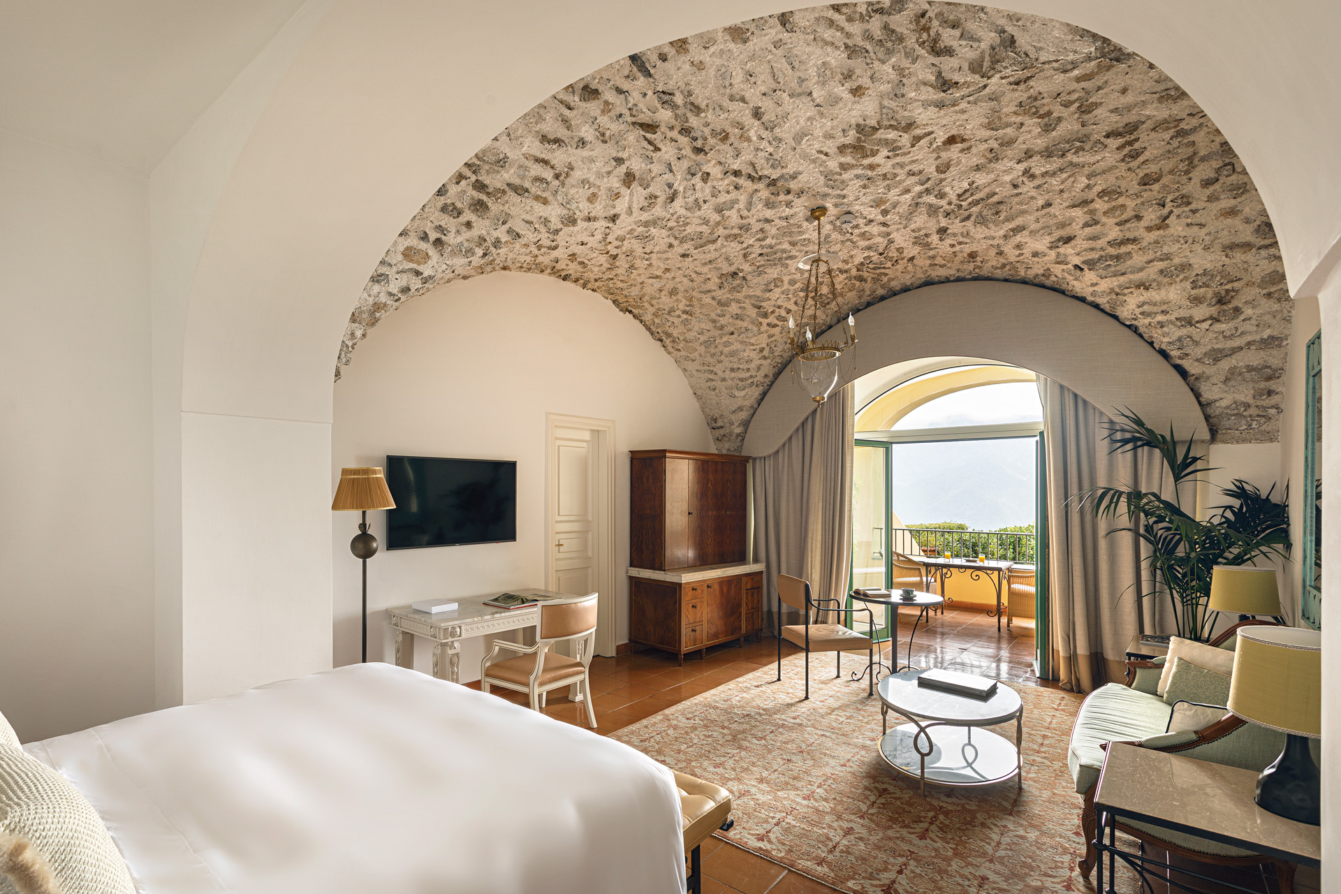 a bedroom with stone dome ceiling at Belmond Caruso