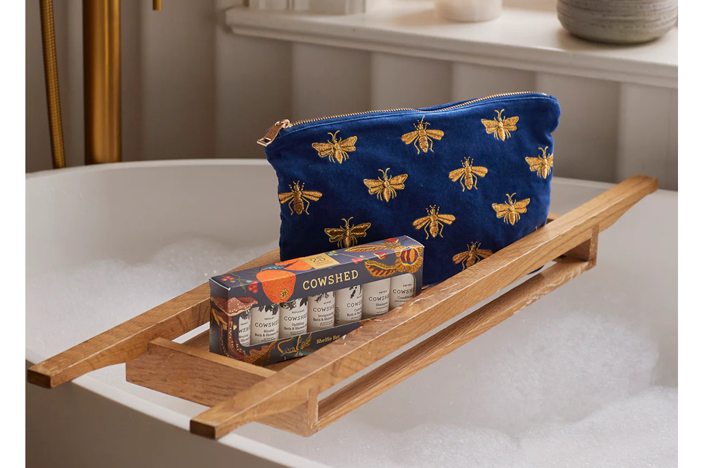 Blue washbag with soaps over bath on bath tray