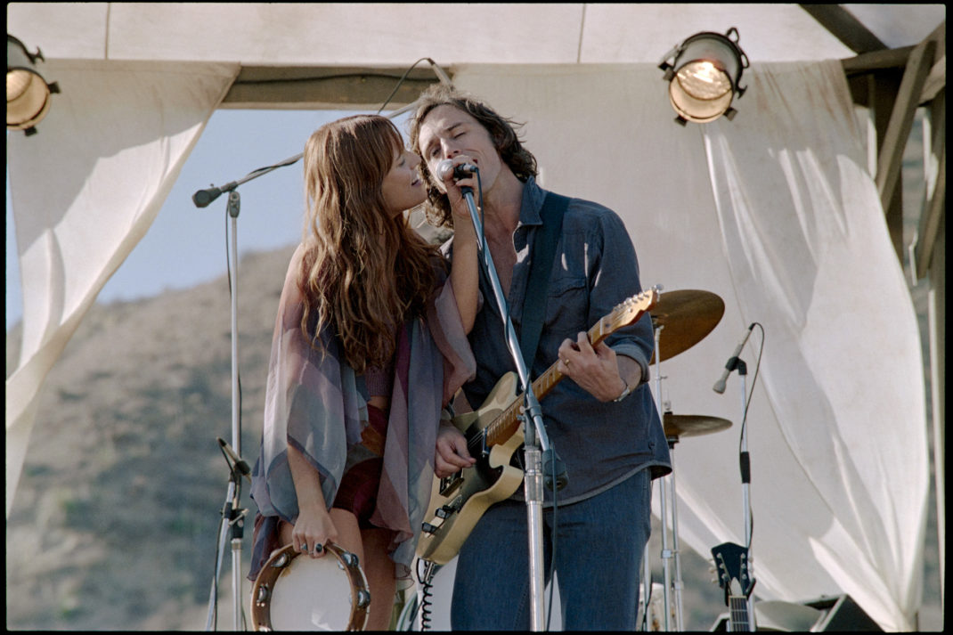 daisy and billy singing onstage in Daisy Jones and The Six