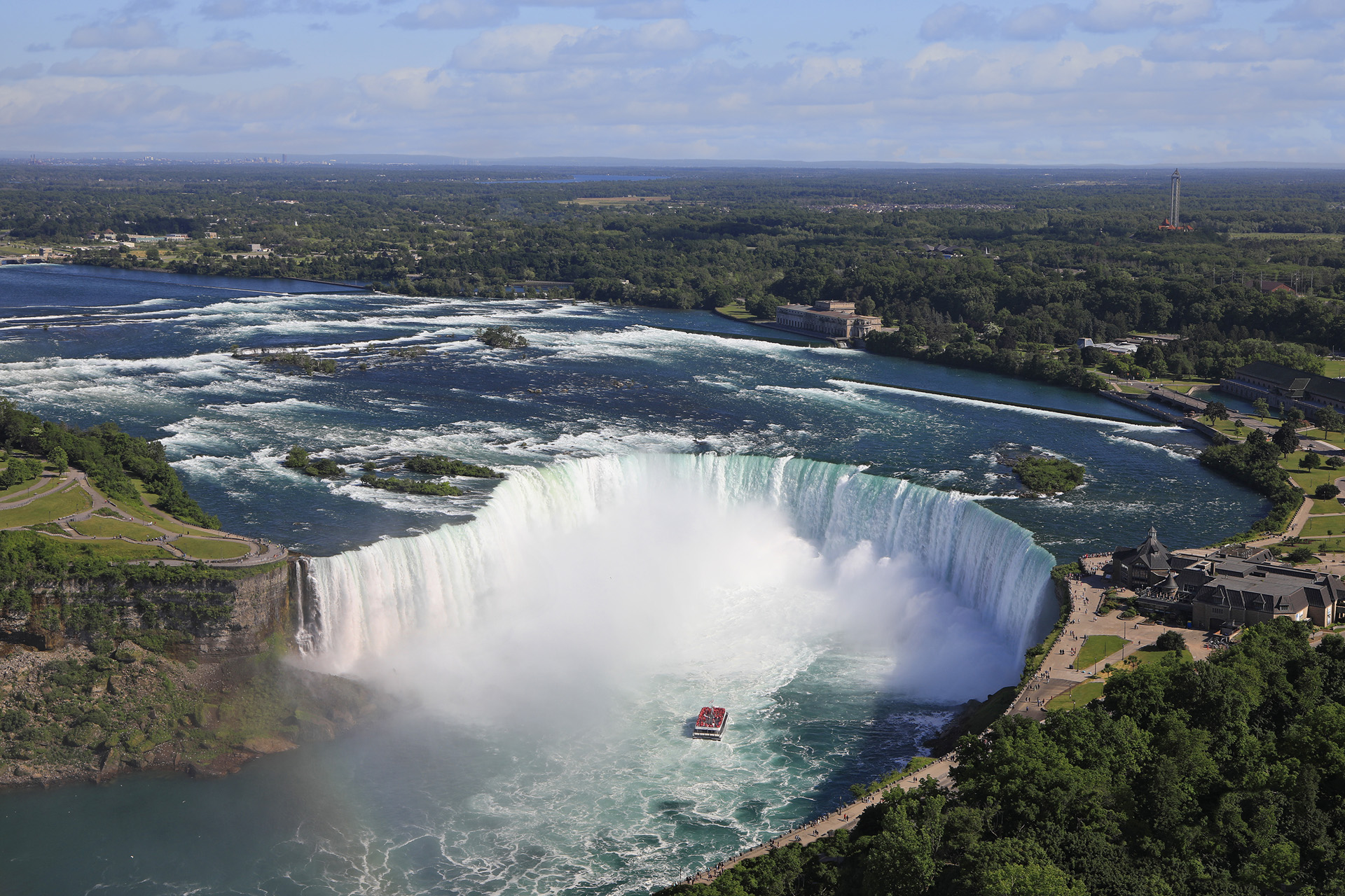 Aerial view of Horseshoe Falls including Hornblower Boat sailing on Niagara River, Canada and USA natural border