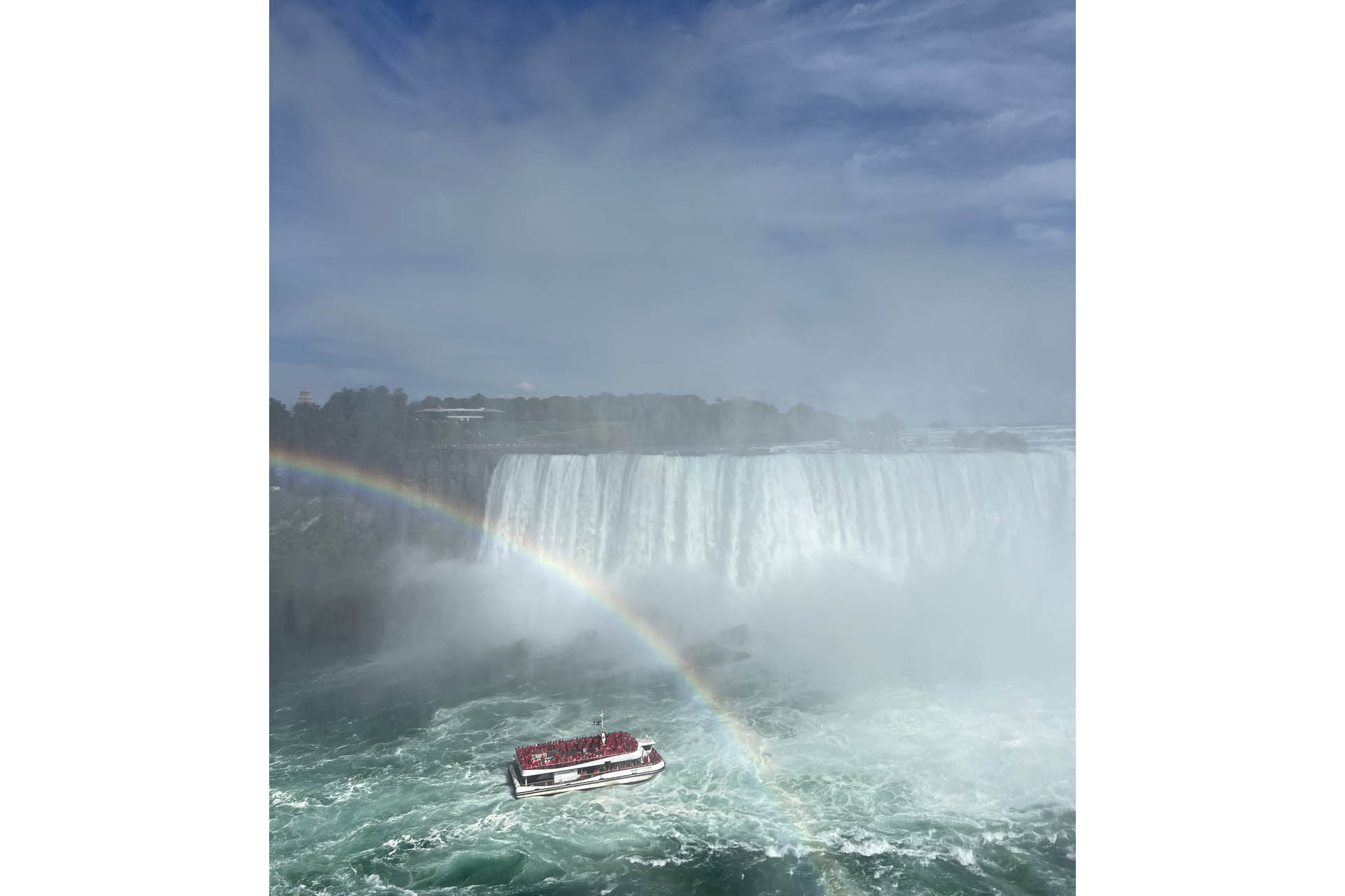 a boat and rainbow at niagara falls