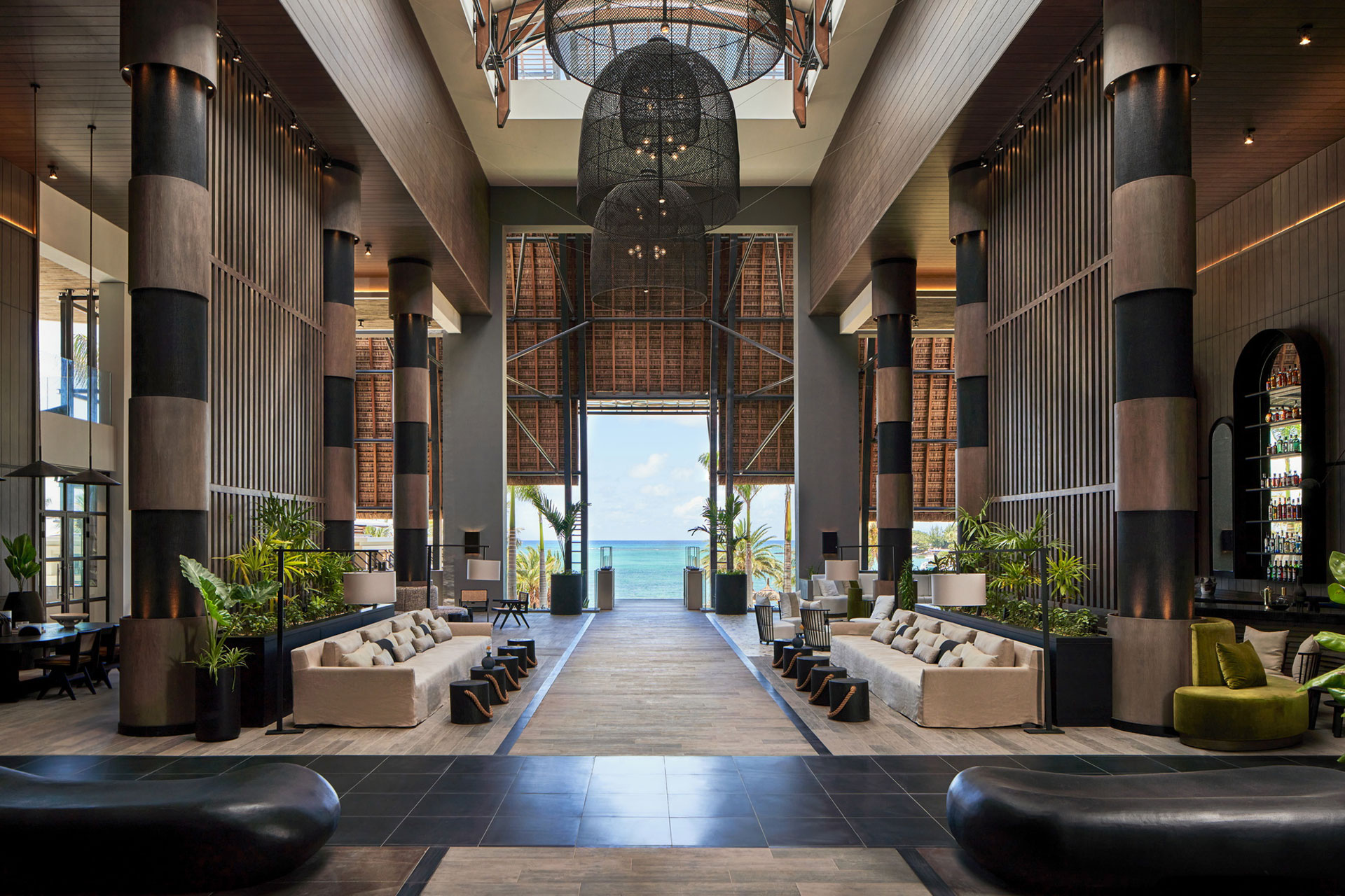 Contemporary hotel lobby with high ceilings and stone walk path in the center