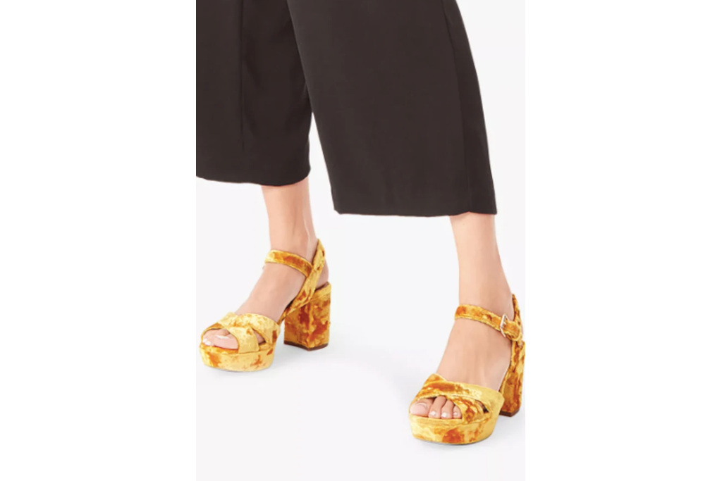 Close up of feet in yellow velvet sandals