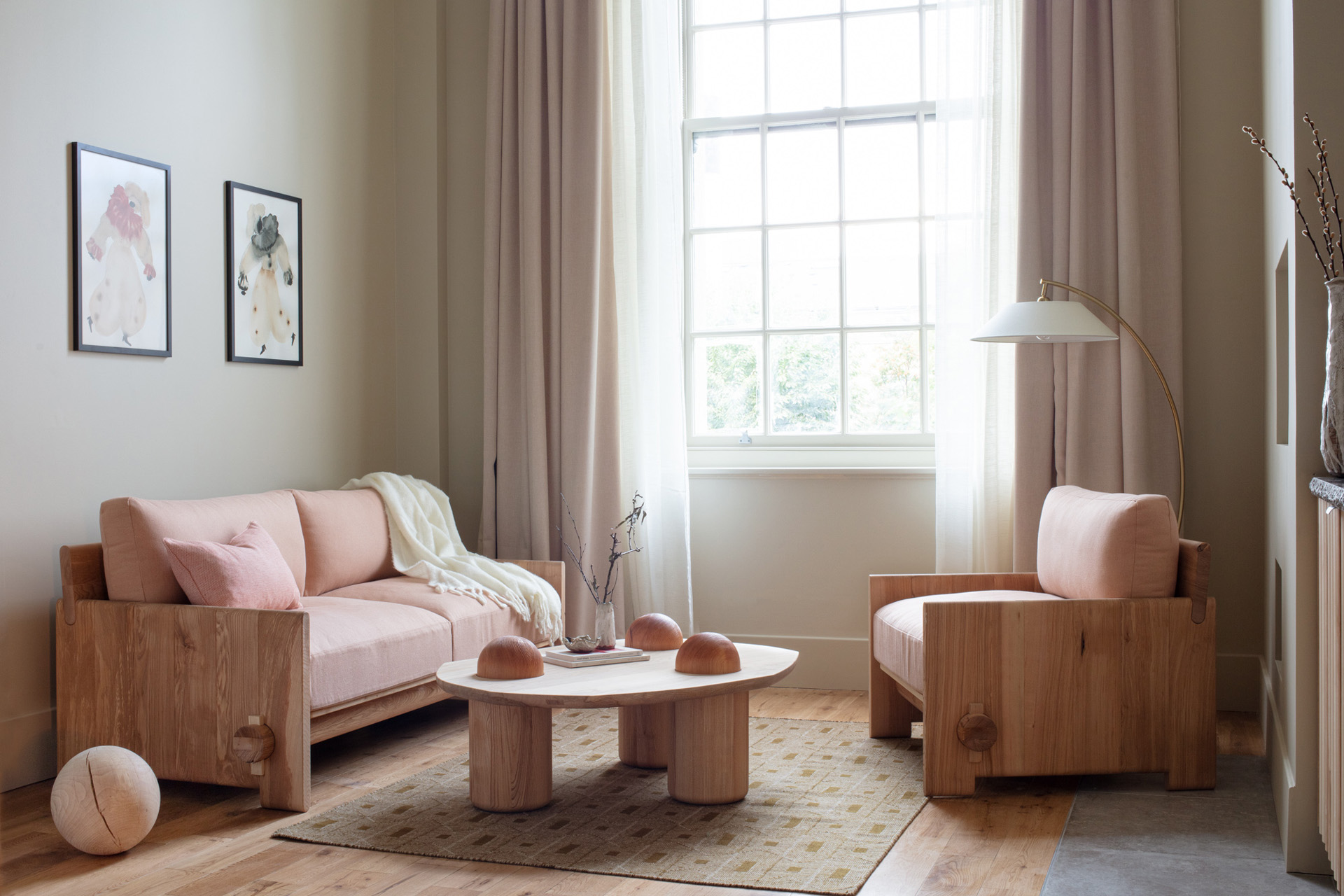 a bedroom in a hotel with a pink sofa