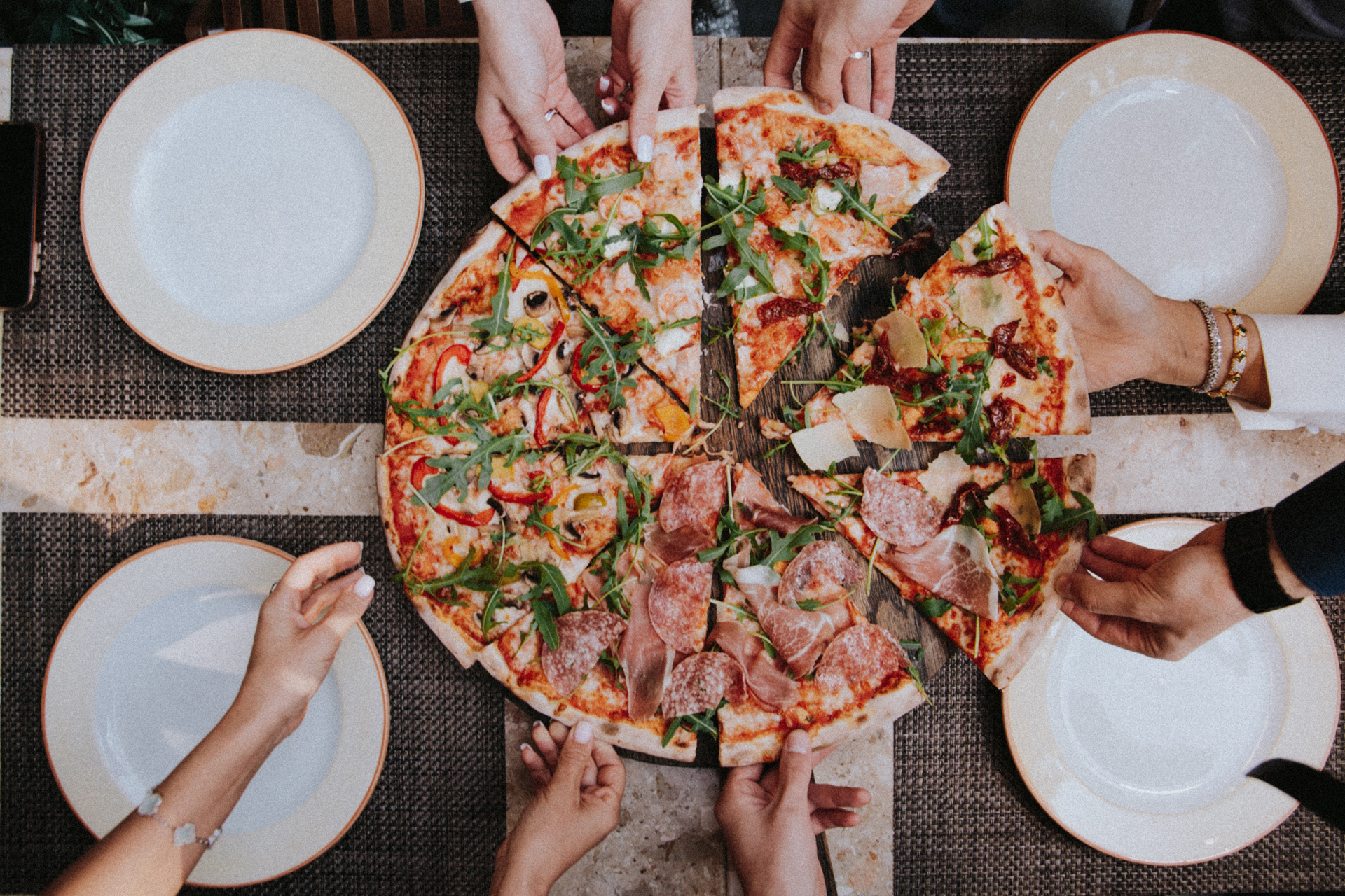 People sharing a pizza