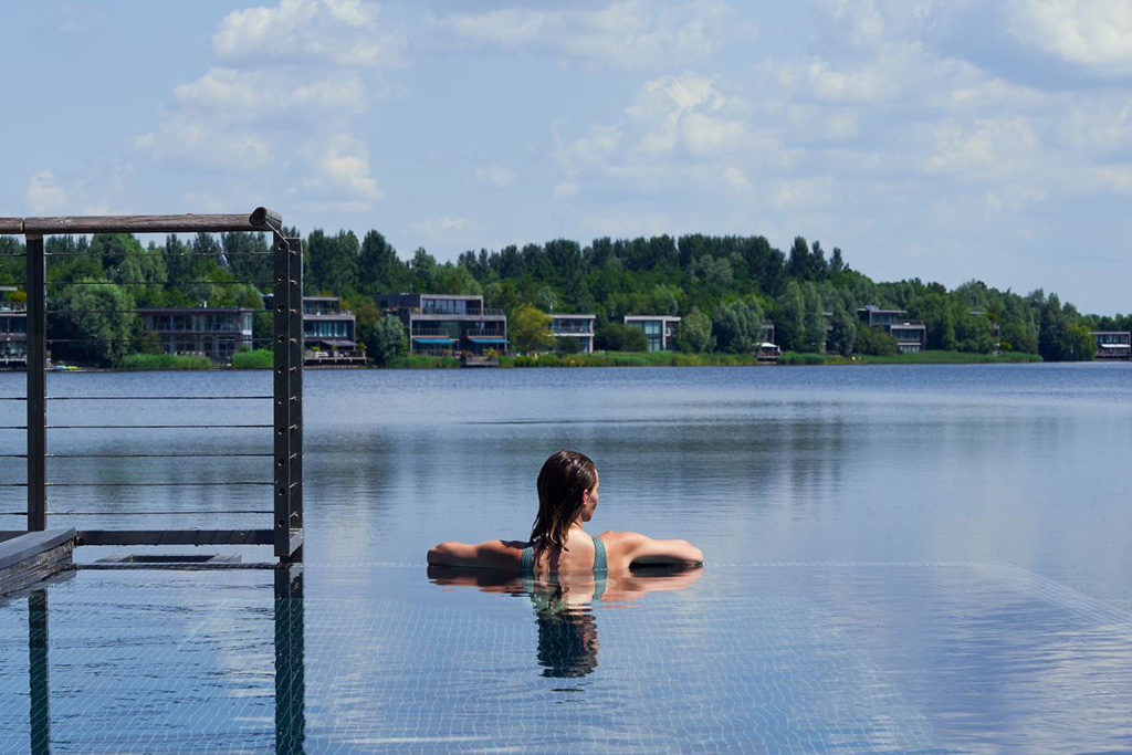 Someone swimming in a pool at The Lakes By Yoo