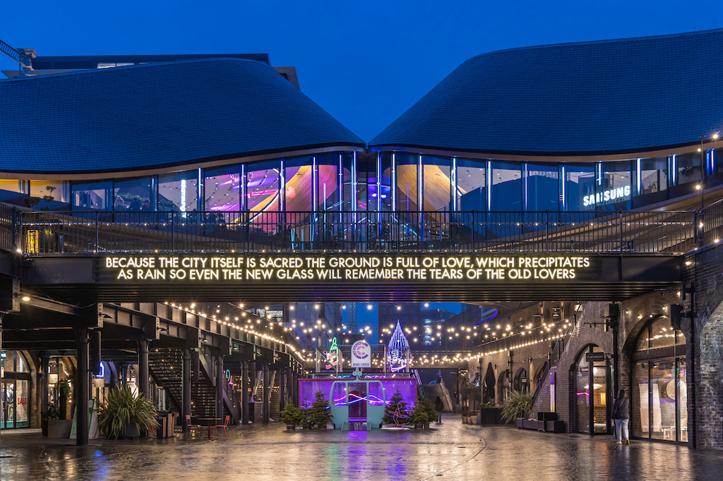 'Because the City itself is Sacred' a light poem by Robert Montgomery, installed in Coal Drops Yard at King's Cross