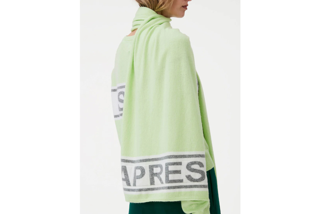 Woman in green jumper and scarf