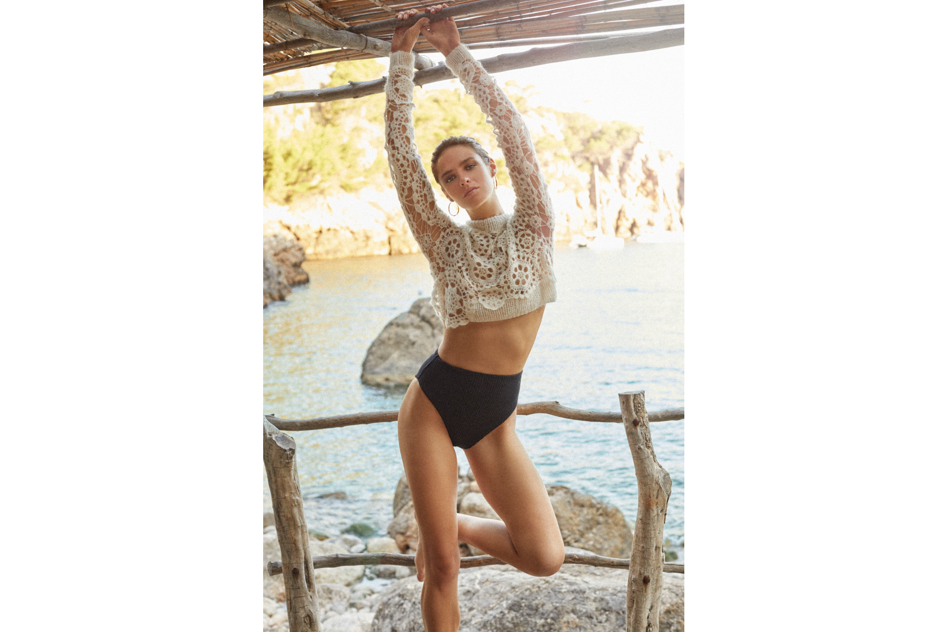 Woman in white top and black pants stretching