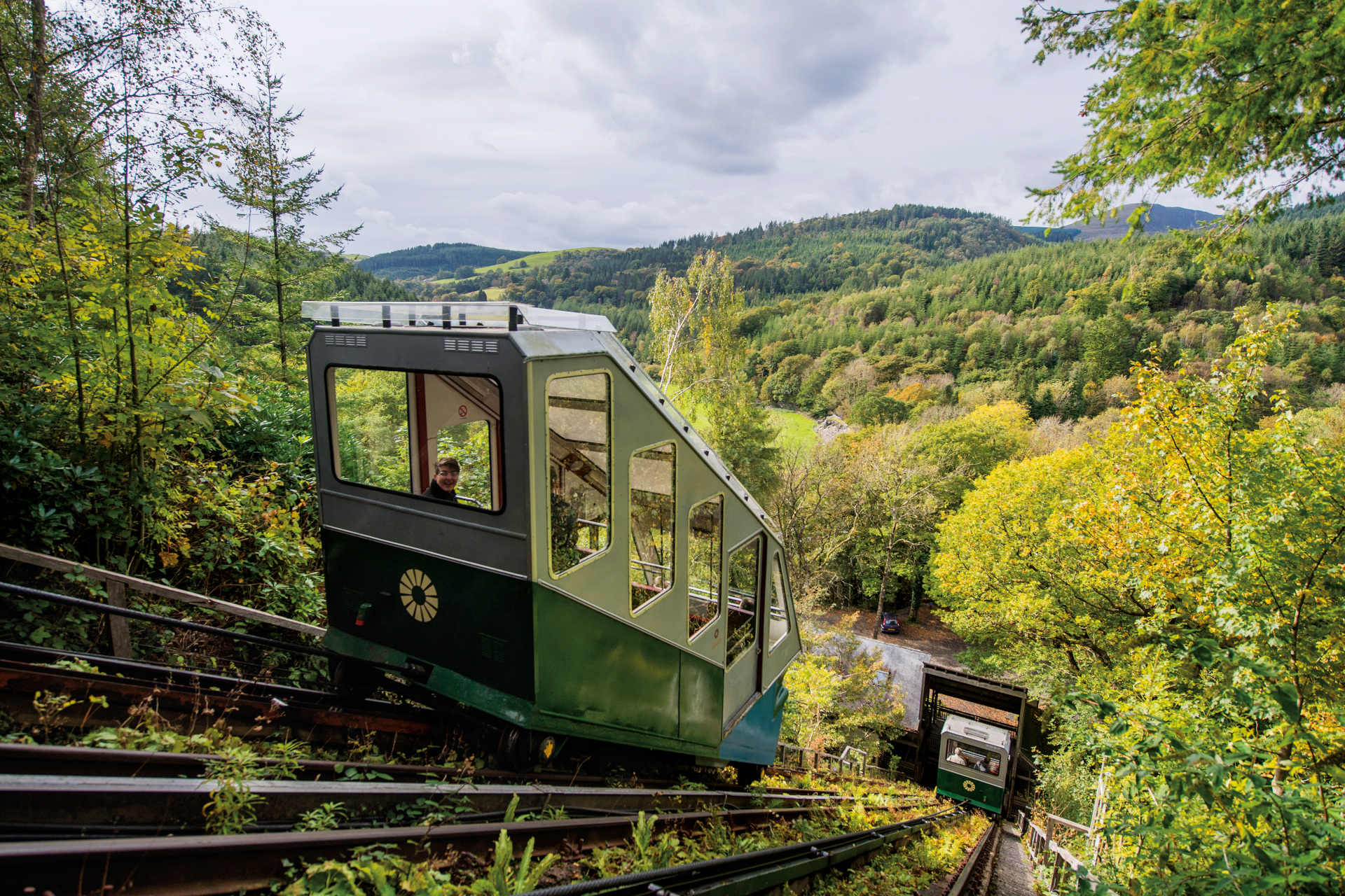 Uphill transport system on tracks on wooded hill