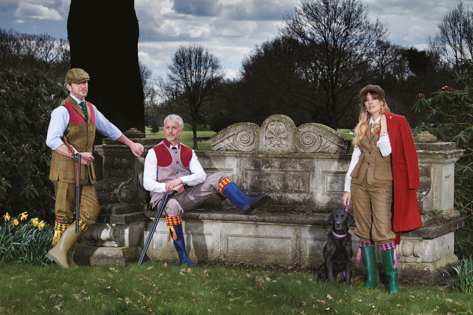 Three people in country clothes stood outdoors