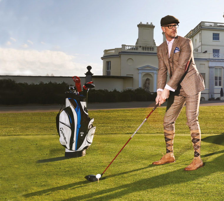 Man golfing outdoors