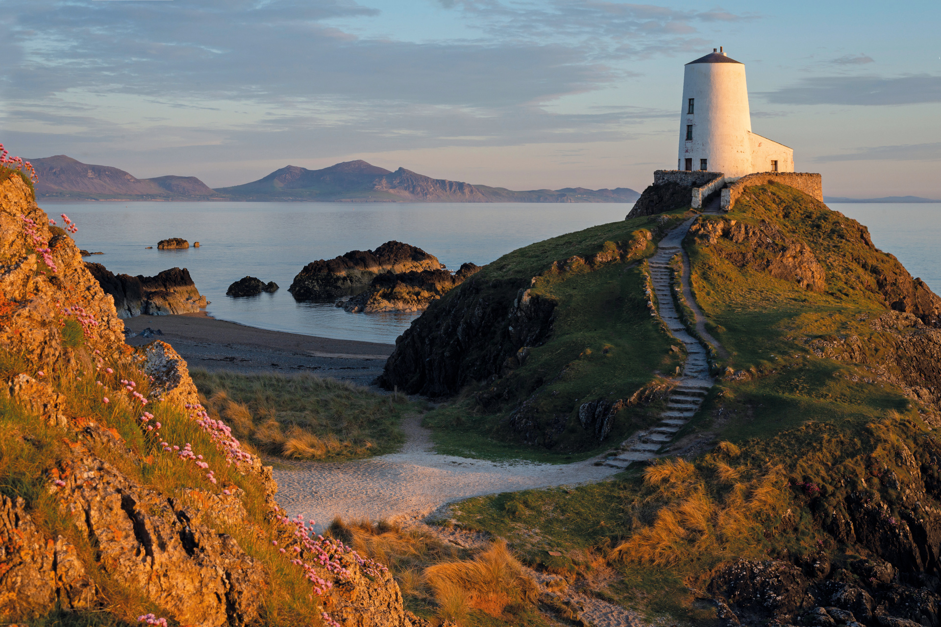 Llanddwyn Island Lighthouse in Snowdonia National Park at sunset, North Wales.