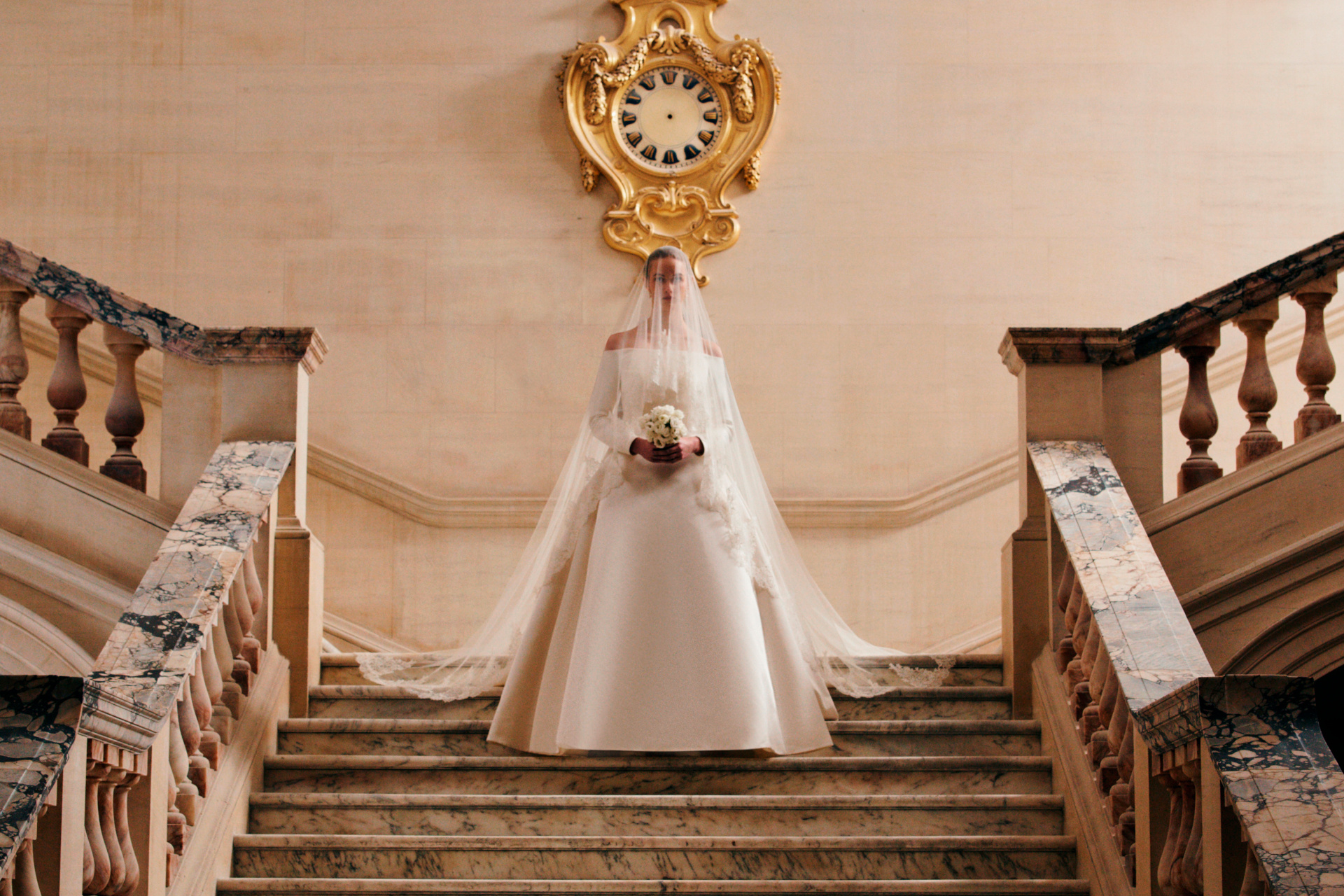 Woman in wedding dress walking down stairs