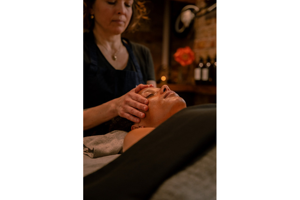 Woman receiving a head massage from a masseuse 