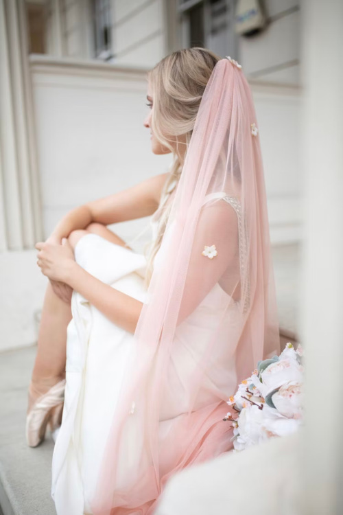 Woman wearing pink bridal veil