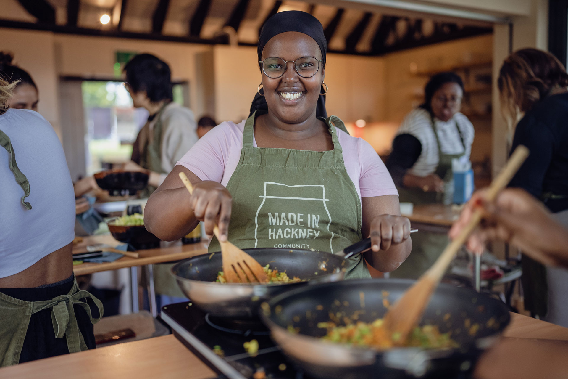 Woman cooking at Made in Hackney cookery school
