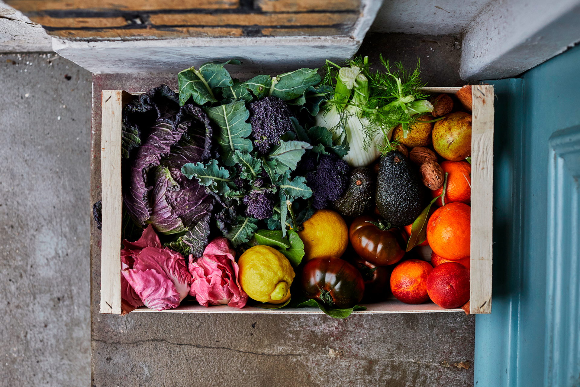 Box of seasonal fruit and vegetables on doorstep