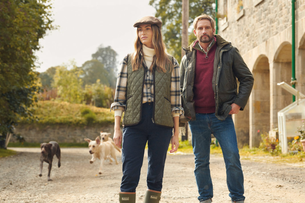A man and a woman dressed in Barbour clothing