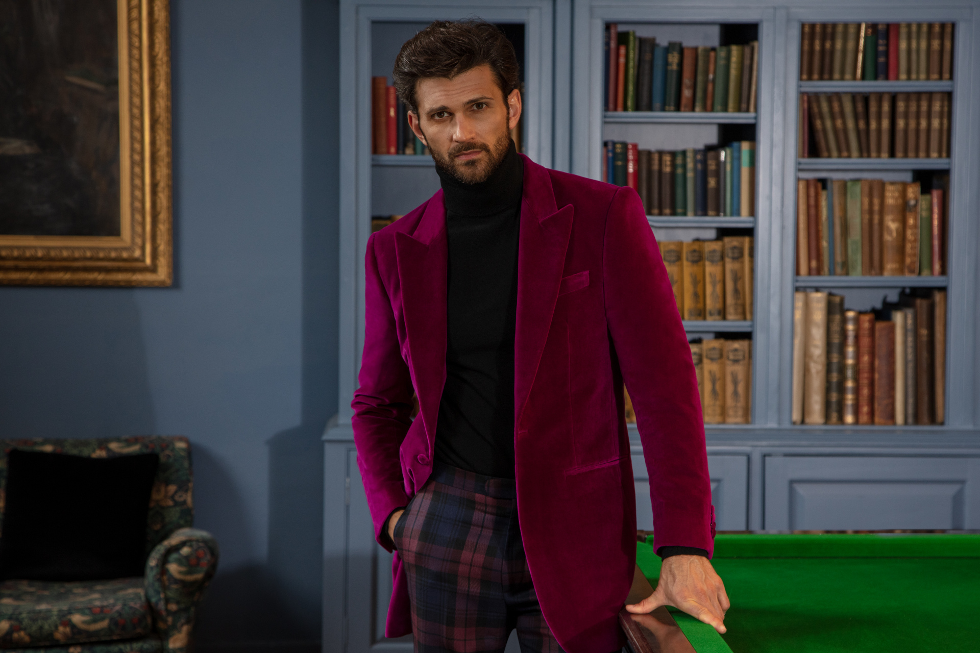 Man stood at snooker table wearing red velvet jacket