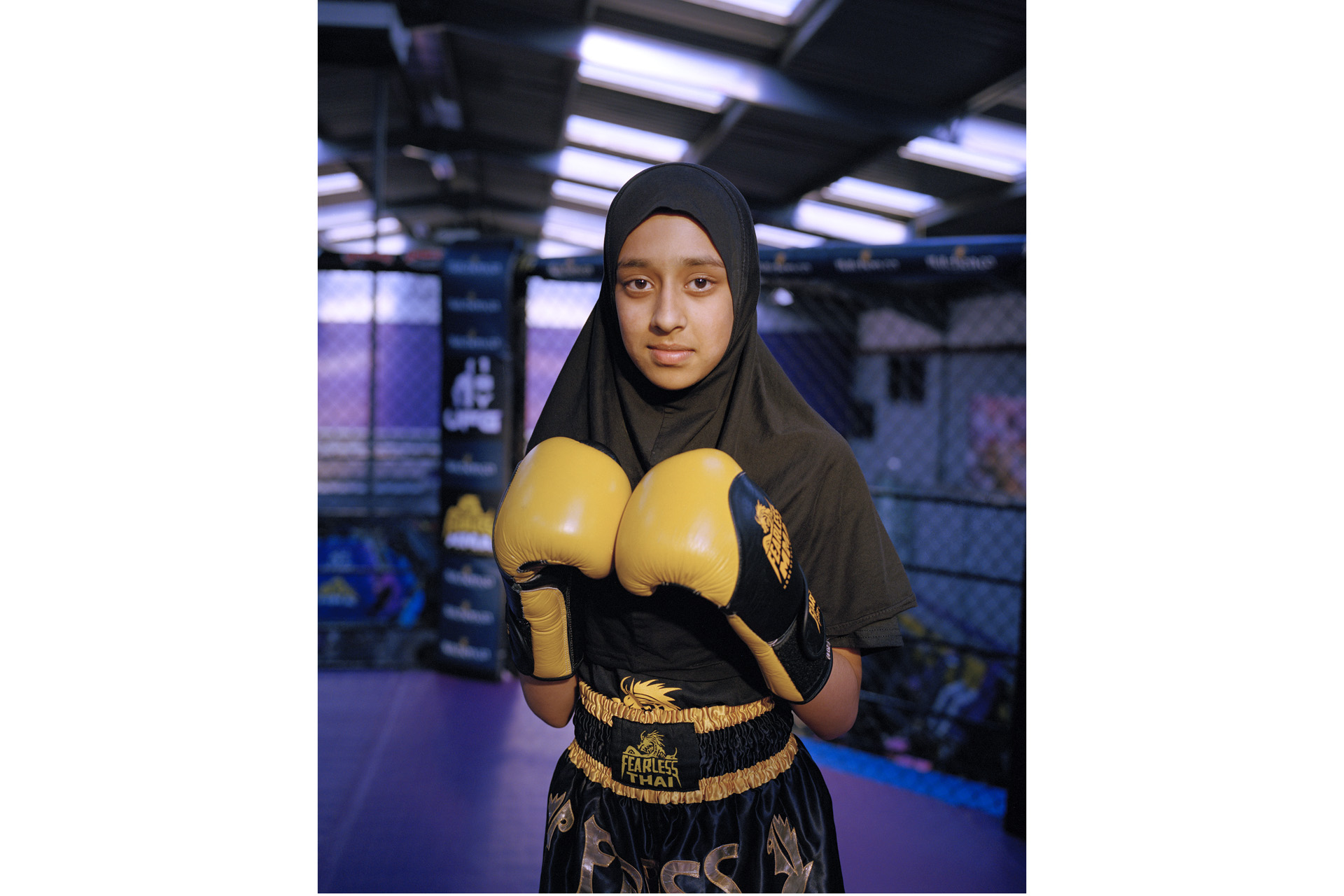 A girl in a hijab and boxing gloves, from Portrait of Britain Vol 5