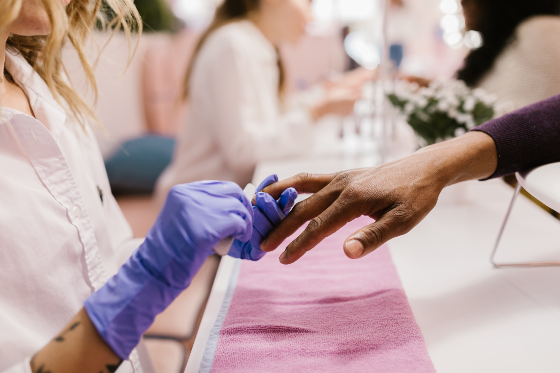 Someone getting their nails painted at a salon