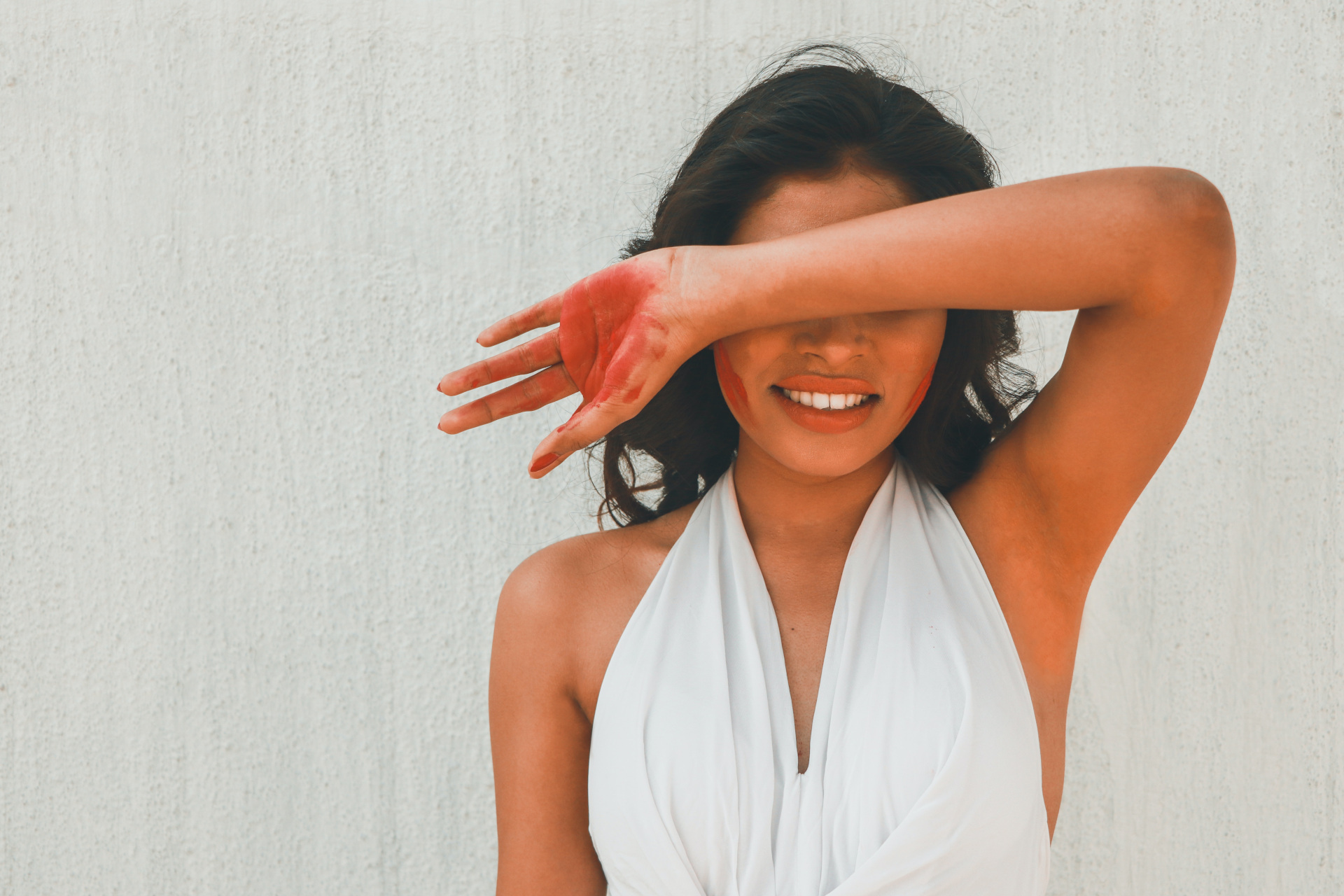 Woman with arm up covering her face