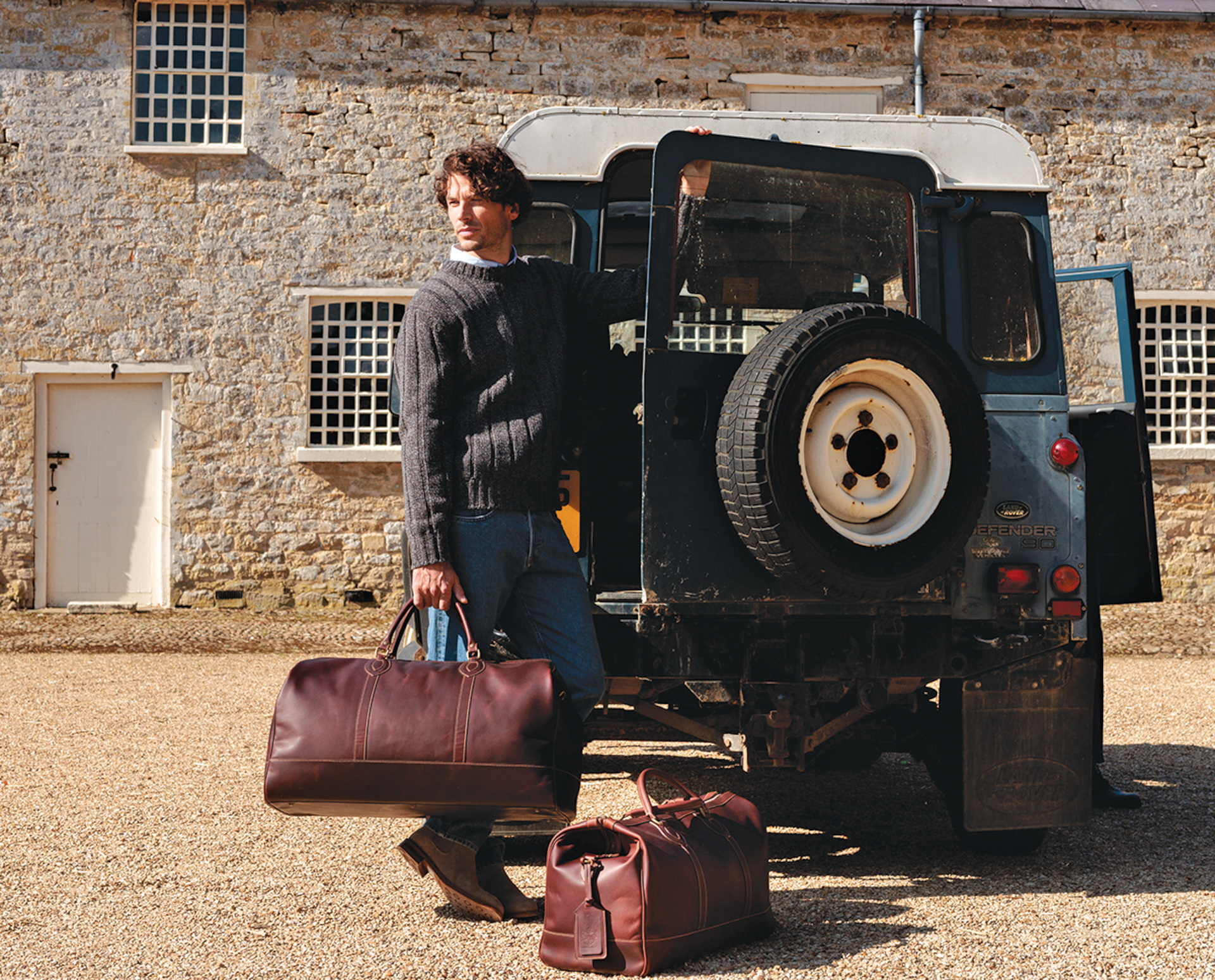 Man with bags next to car | british men's bag brands
