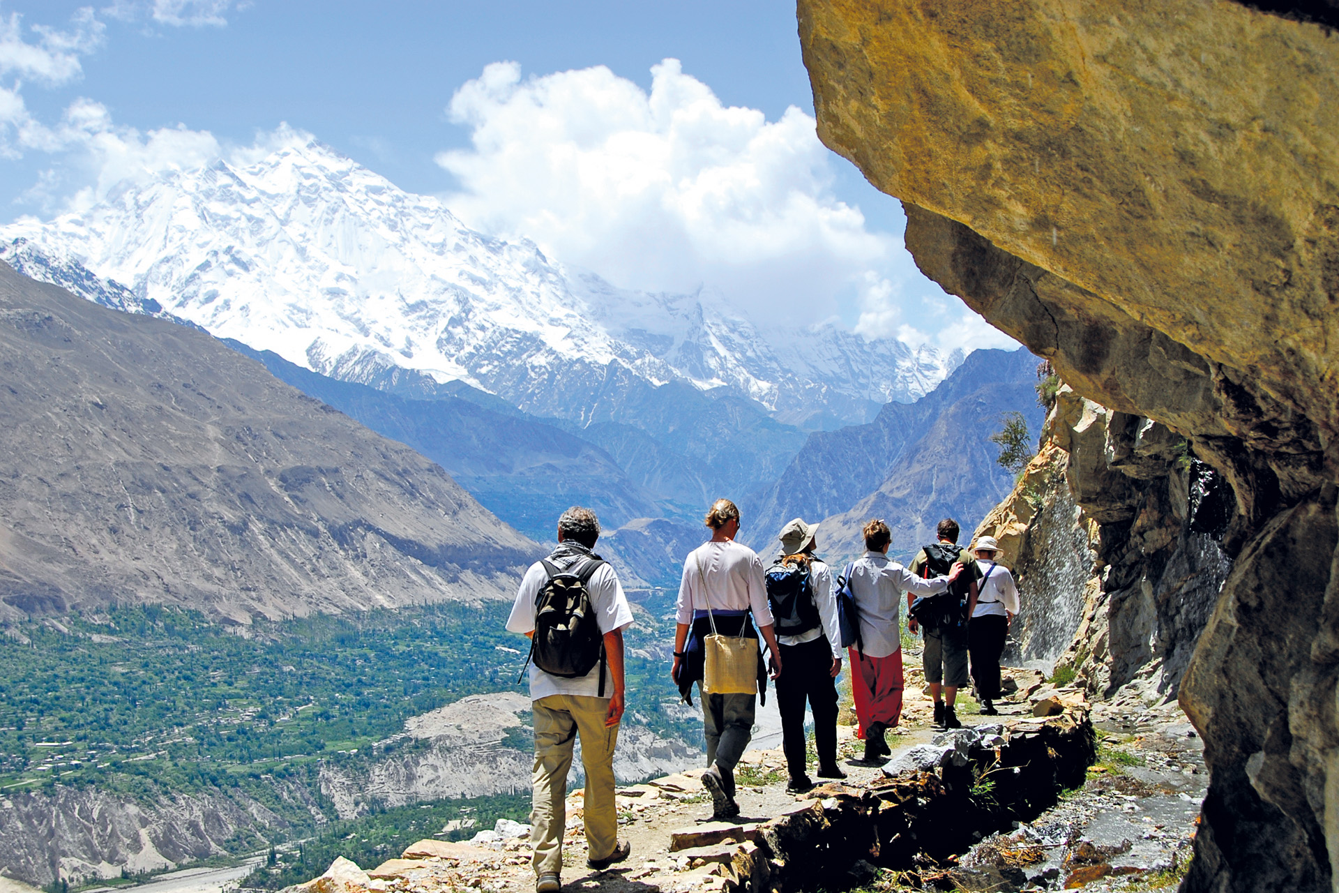 hikers alongside a mountain