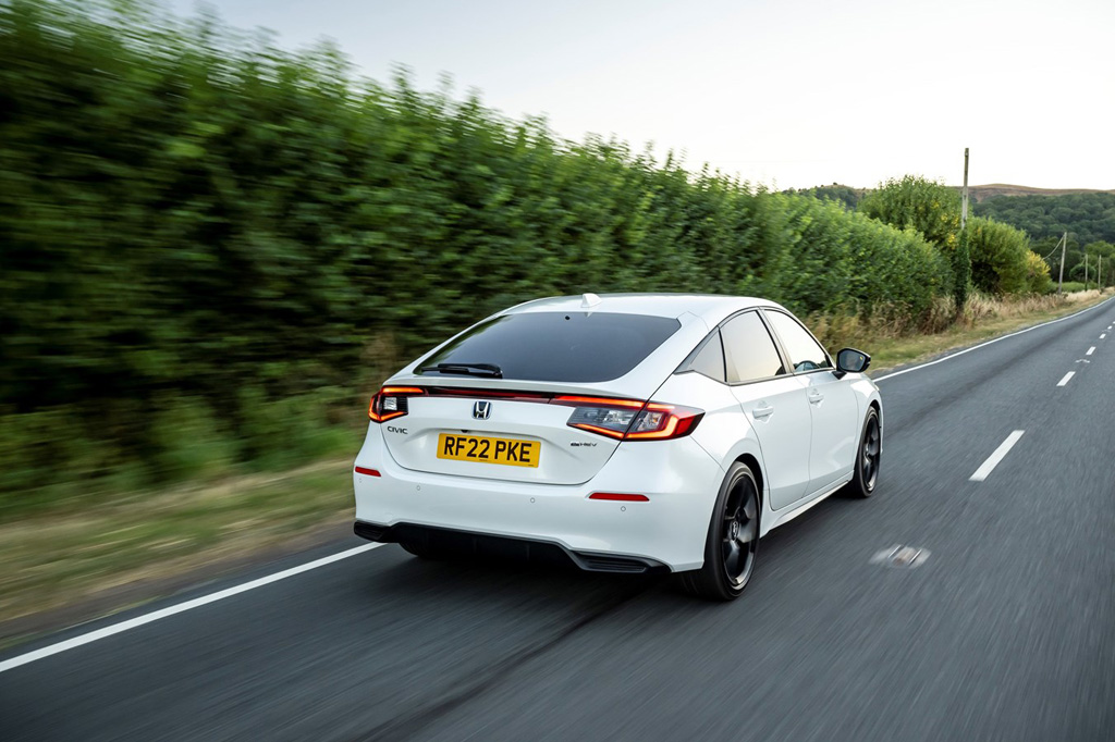 The rear of the Honda Civic eHEV driving along a road