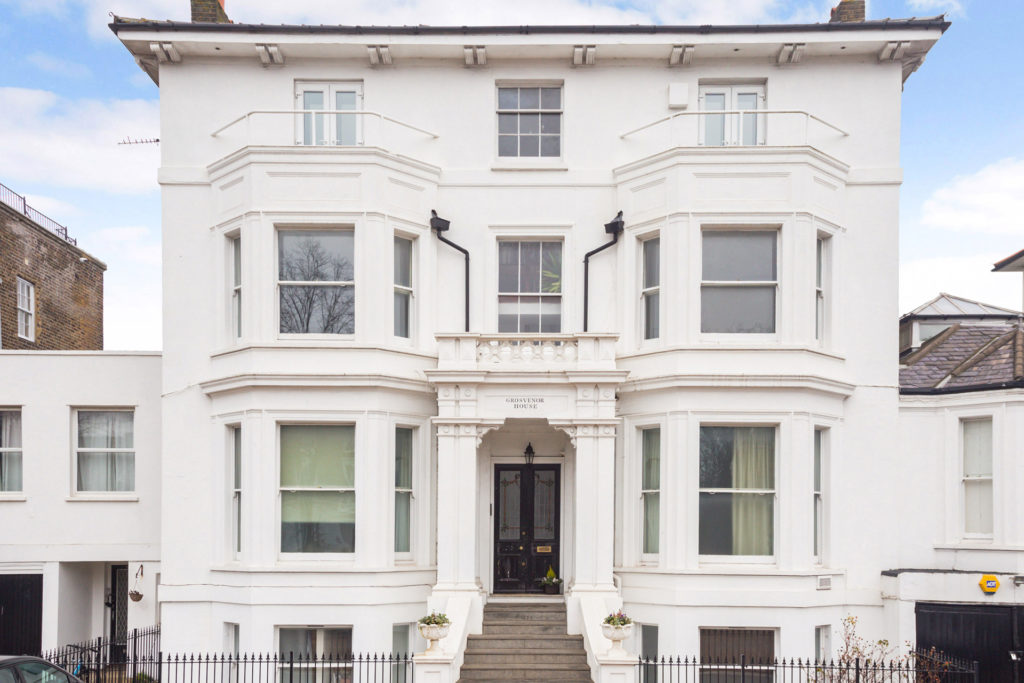 White exterior of a large house in Blackheath, with sash windows and steps leading to the front door
