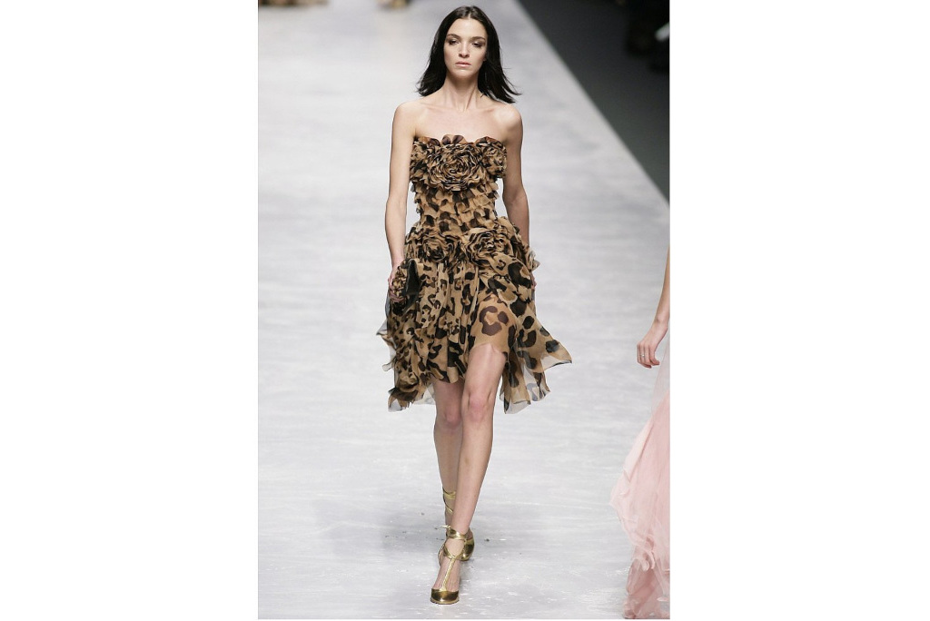 Woman walking runway in corsage dress