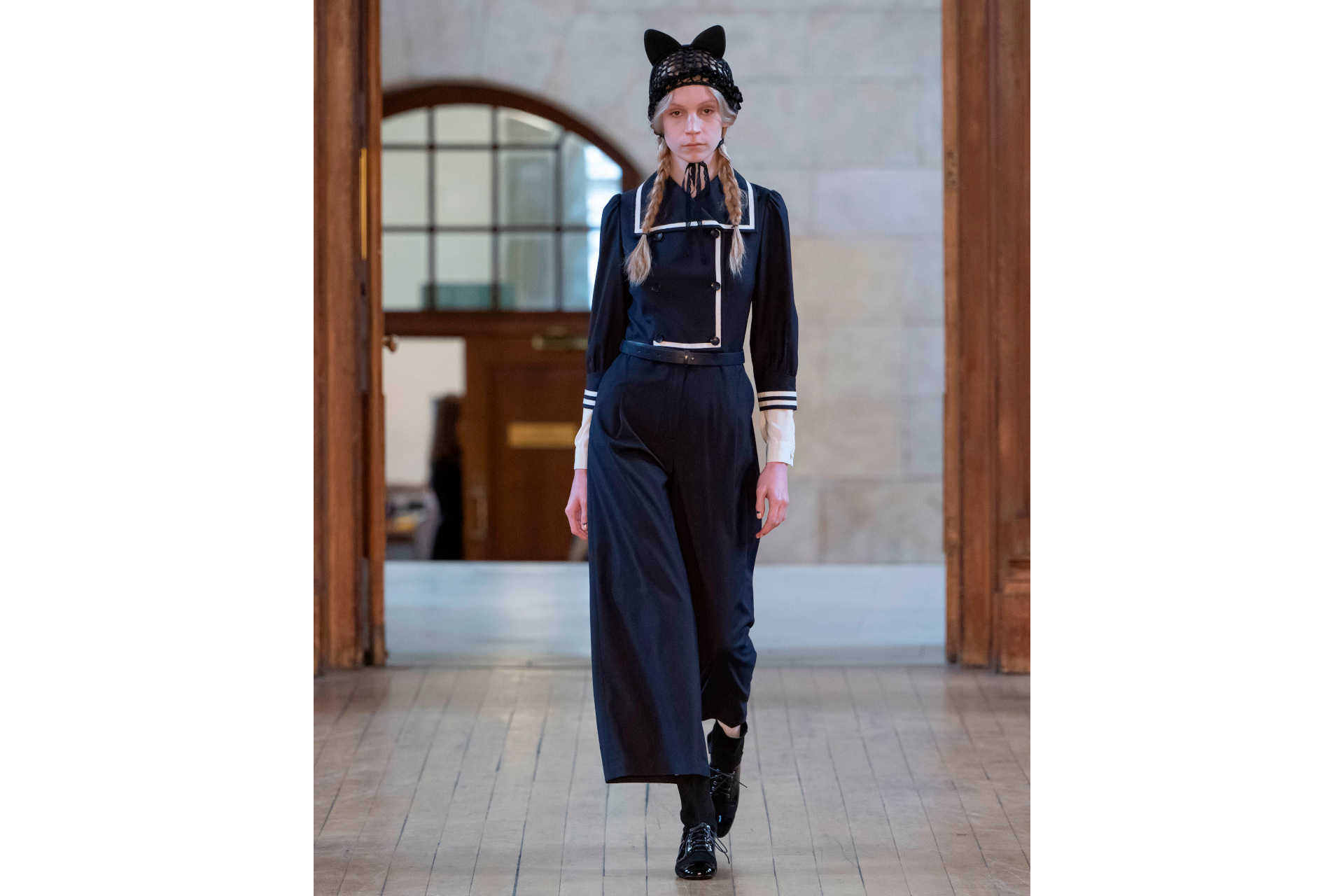 Woman in black suit and cat ear hat