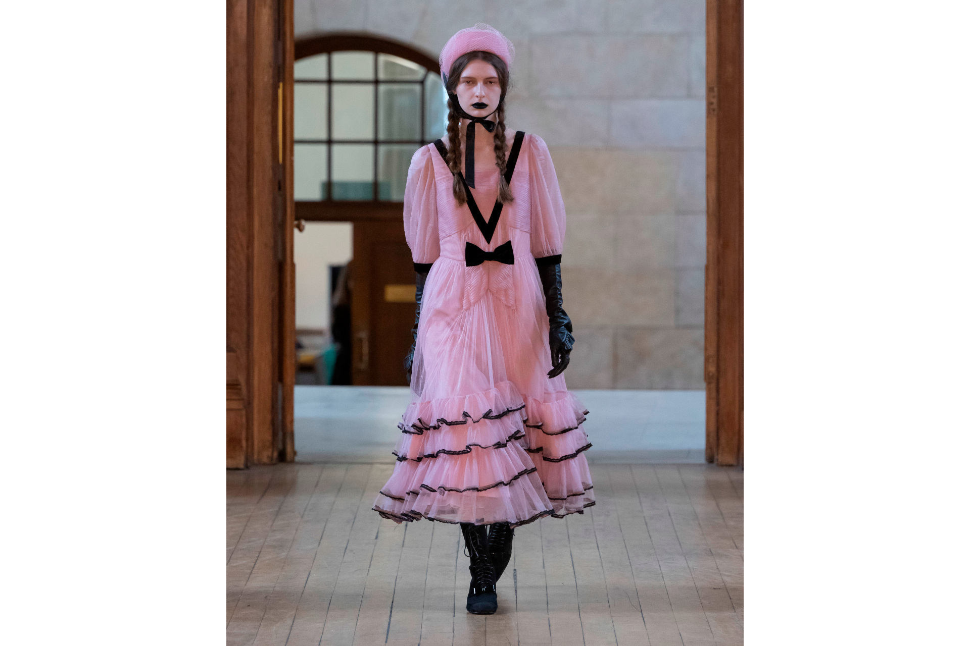 Woman in pink ruffle dress and hat