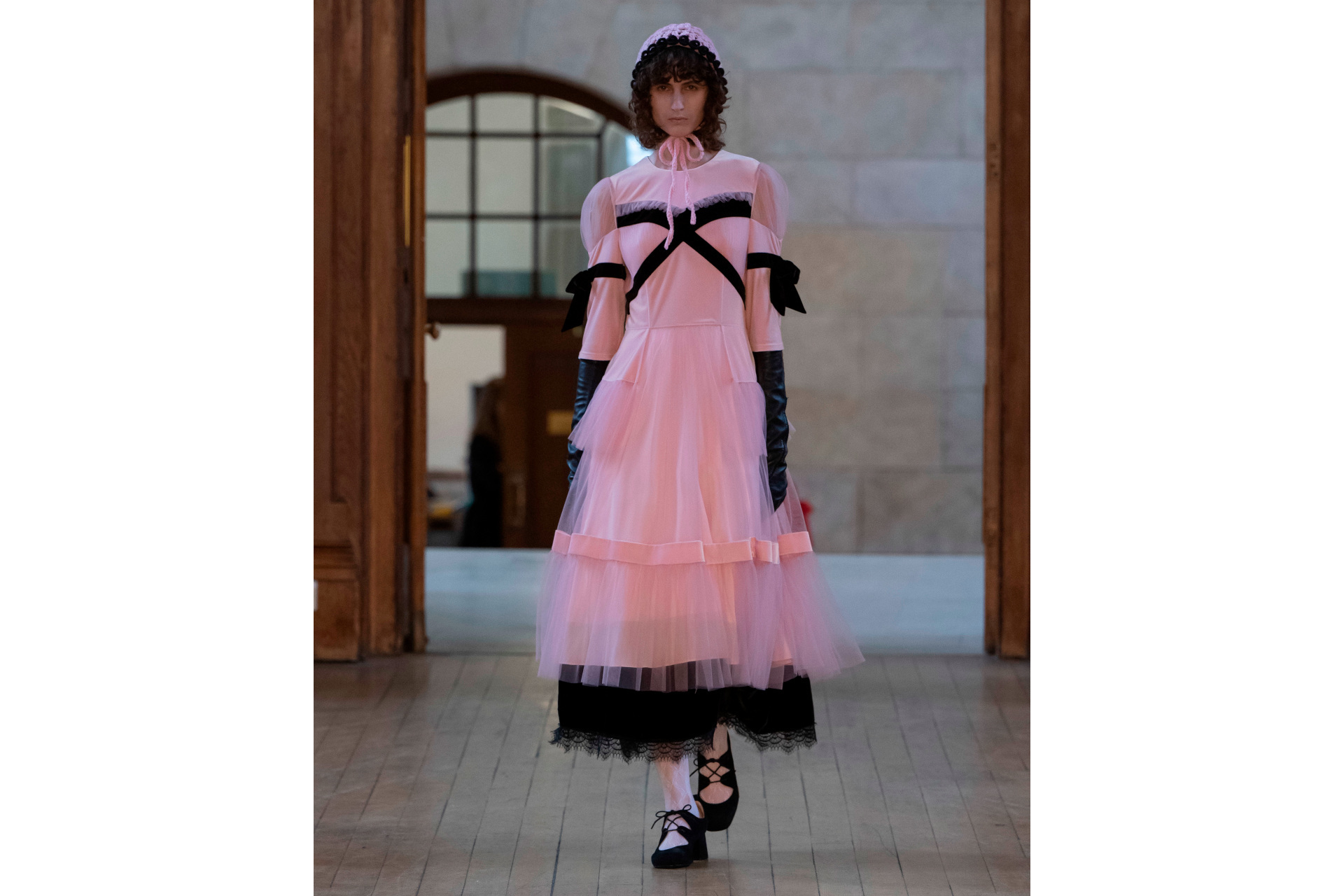 Woman in pink and black ruffle dress