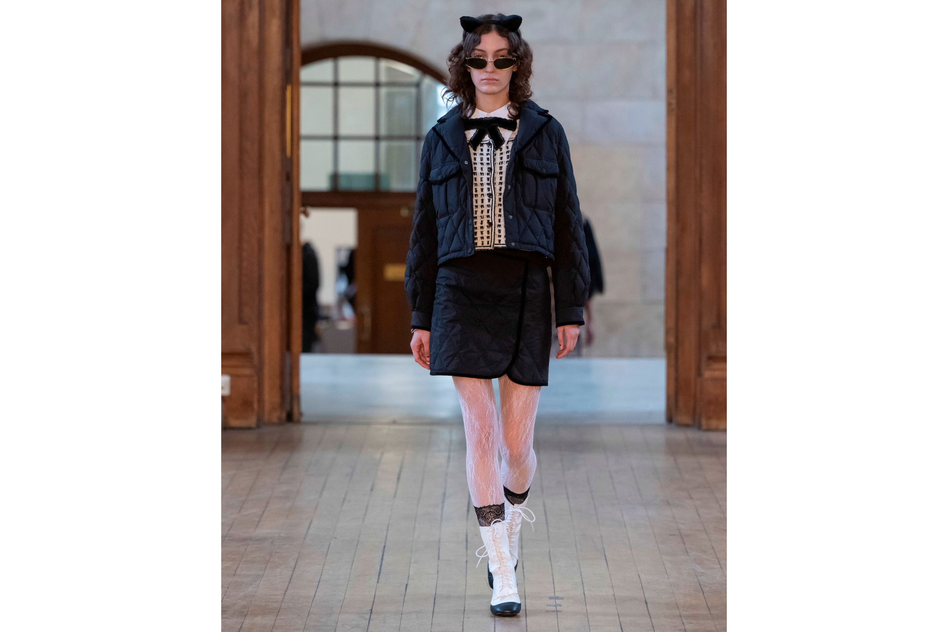 Woman in black skirt and jacket with white shirt